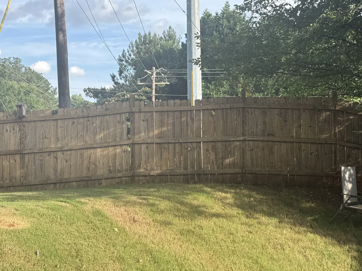 Wood fence after pressure washing by JR Pressure Pros — natural warm brown wood tone fully restored