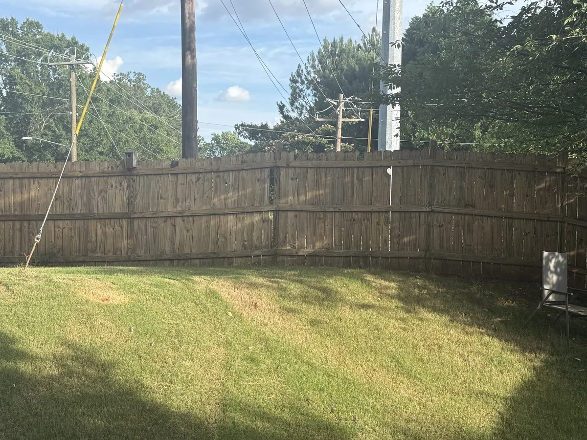 Wood fence after professional cleaning — clean restored wood grain, Atlanta GA