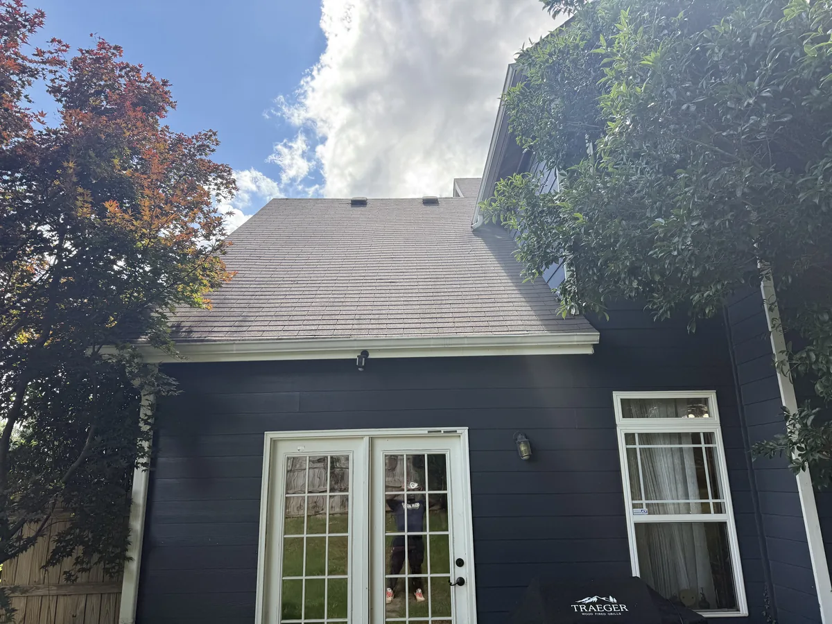 House exterior after soft wash by JR Pressure Pros — clean navy fiber cement siding and roof, Atlanta GA