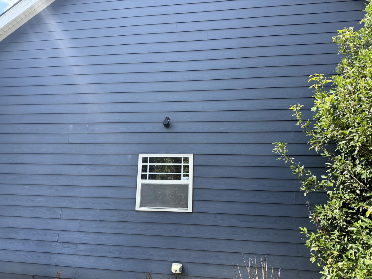 Side of Atlanta home after professional house washing — spotless horizontal fiber cement siding