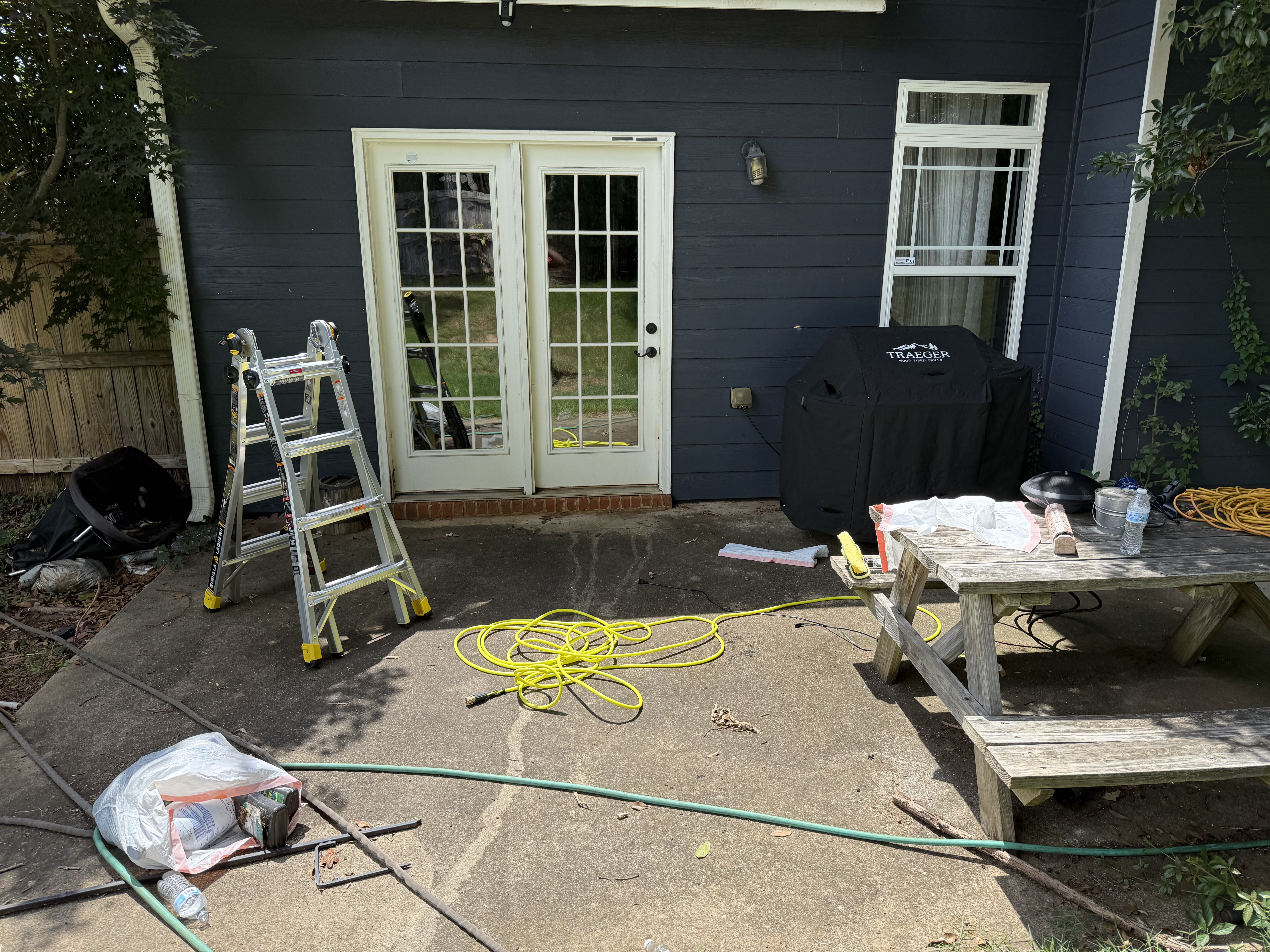 Concrete patio before — dirty, stained, debris